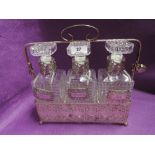 A vintage tantalus decanter set with whisky sherry and gin badges