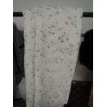 A vintage bed throw or quilt with floral imagry