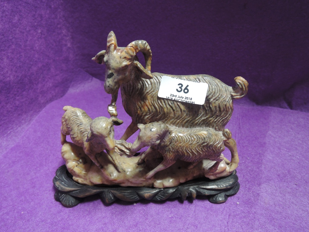 A carved stone figure of a Goat and two kids Indonesian style