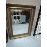 A large modern gilt frame wall mirror
