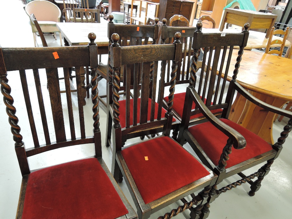 A set of four dark oak chairs and matching carver