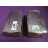 A pair of HM silver backed gents brushes having Art deco style engine turned decoration