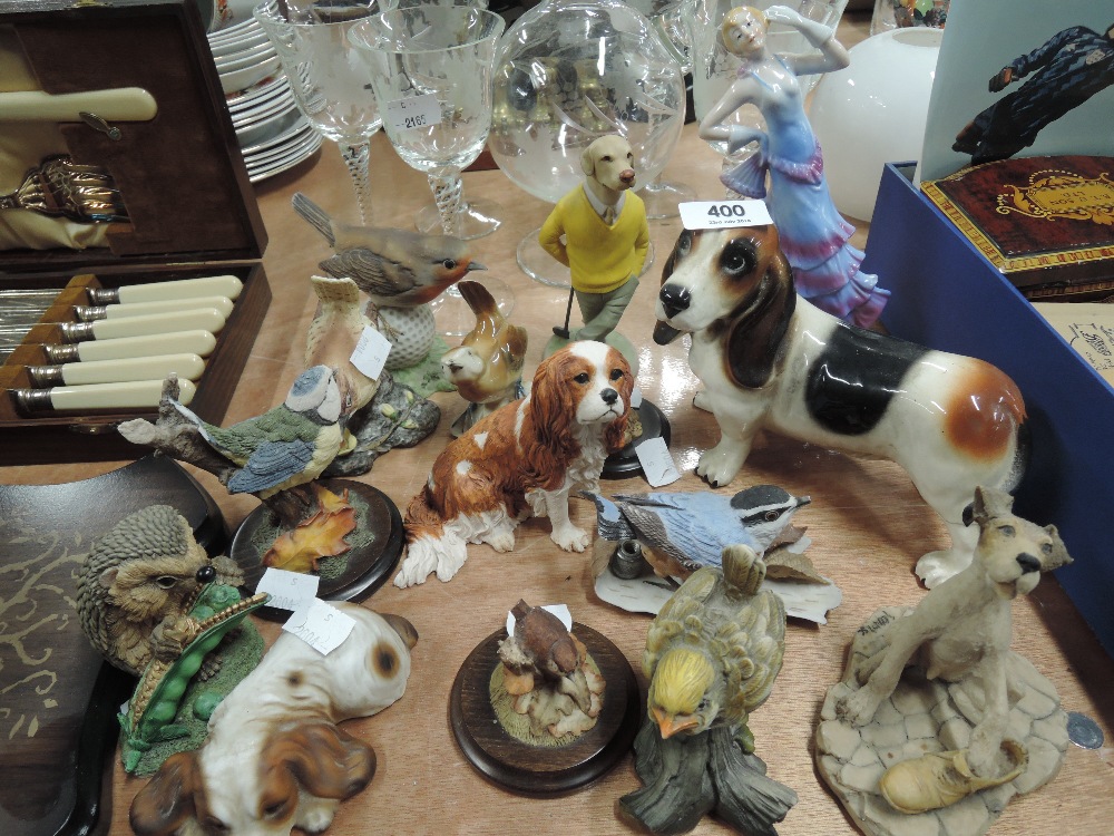 A selection of vintage figures and figurines including golfing dog