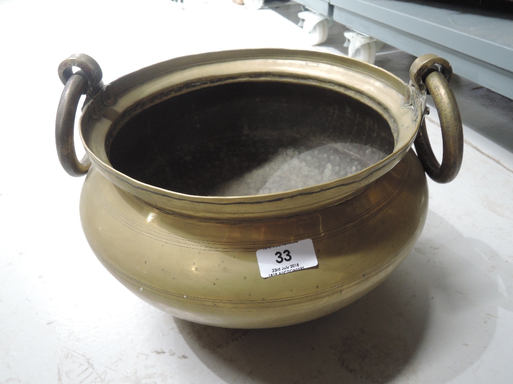 A large heavy brass cast cauldron style planter