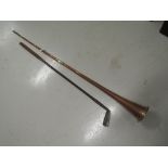 A vintage wooden shafted golf club and a copper and brass post horn