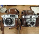 Two vintage photography cameras including Kodak Retinette 1A and Optima