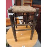 A woven fibre seated stool