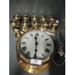 A vintage brass bodied ships style clock and brass door handle selection