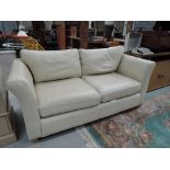 A cream leather modern couch sofa