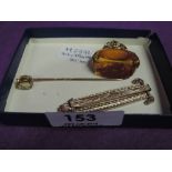 Three pieces of yellow metal and 9ct gold jewellery including stick pin and fob