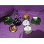 A selection of vintage paperweights and similar green glass stamp weight