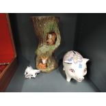 A selection of vintage decorations including painted piggy bank