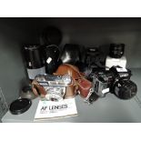 A selection of vintage photography equipment lens and cameras including Minolta 70 - 210 and 7000