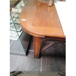 An early 20th century mahogany drawer leaf dining table having heavy square legs and X frame base,