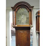 A late 18th/early 19th century oak longcase clock having arch and pillar hood containing brass
