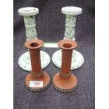 A pair of 19th century ceramic candlesticks having naturalistic decoration and a pair of 19th