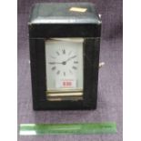 A brass frame carriage clock of traditional four glass design in leather case