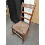 A 19th century beech rocking chair having rush seat and ring turned frame