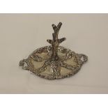 An Edwardian ring tree having having repousse floral decoration, moulded handles and Xmas