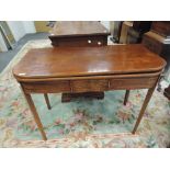 An early 19th century mahogany tea table having line inlay decoration on tapered gate legs