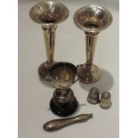 A selection of HM silver including two bud vases of traditional form, a miniature trophy, two