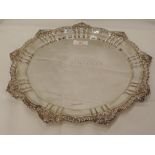 A silver salver having a moulded gadrooned and shell pie crust border, presentation inscription to