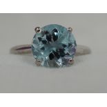 A lady's dress ring having an aqua marine style solitaire, approx 1.5ct in a 4 claw raised mount