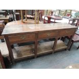 A 19th century oak dresser base in the 17th century style having 3 frieze drawers on square leg