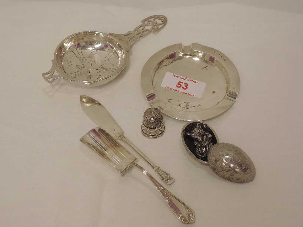 A small selection of HM silver and white metal including ash tray, tea strainer, thimble, sugar
