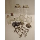 Six glass bottles and cut glass vases having HM silver collars, stands and lids, an HM silver bottle