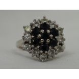 A lady's dress ring having a hexagonal sapphire and diamond triple cluster in a claw set basket