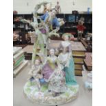 A 19th century Continental figure group in the Meissen style fruit pickers and putti amidst tree