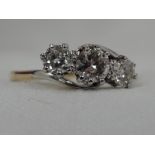 A lady's dress ring having a trilogy of diamonds, total approx .65ct, in claw set mount to crossover