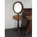 A late Victorian mahogany shaving stand having circular adjustable mirror on pedestal base with