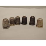 Four HM silver thimbles and two white metal thimbles, all of traditional designs