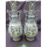 A pair of early 20th century Satsuma pottery vases of step handle design having typical pictorial