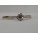 A lady's diamond solitaire dress ring, approx 0.25ct in a claw set mount on a yellow metal loop,