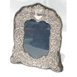 A modern silver photograph frame of arched form having moulded decoration on navy velvet, Birmingham