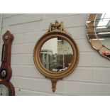 A late 20th century Regency style wall mirror having urn and swag decoration