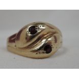 A 9ct gold serpent ring having garnet set eyes, size T (AF)