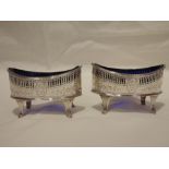 A pair of Georgian silver salts of boat form having pierced and engraved decoration, monogrammed