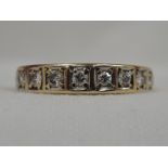 A lady's half eternity ring having eleven diamonds, total approx 0.45ct in claw set square mounts on