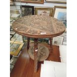 An early 20th century hardwood occasional table having circular top of Scottish design having celtic