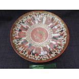 A late 19th century Satsuma pottery charger having pictorial immortal decoration on gilt