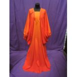 A lady's 1960's orange maxi dress by Susan Small of london having oversized balloon sleeves and
