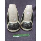 A pair of mid 20th century pottery vases of stylised lava rocket form having mottled cream ground,
