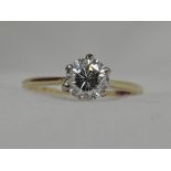 A lady's dress ring having a diamond solitaire, approx 0.70ct in claw set raised mount to knife