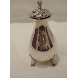 A silver sugar caster of plain baluster form having trefoil scallop and paw feet, shaped rim and