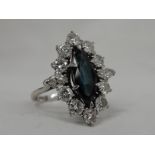 A lady's dress ring having a central marquise cut sapphire, approx 1.75ct surrounded by two marquise