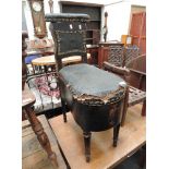 An early Victorian commode chair of cock fighting style, having black leatherette upholstery and